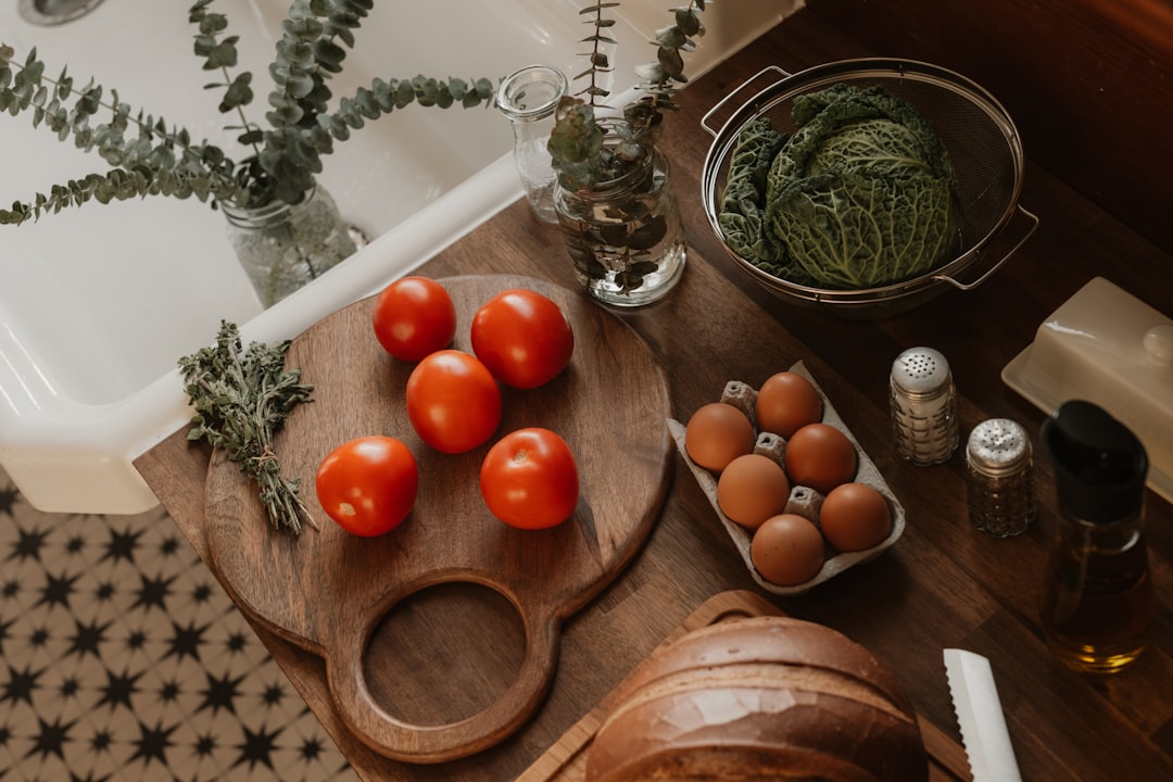Tomatoes, eggs, and cabbage on a kitchen counter