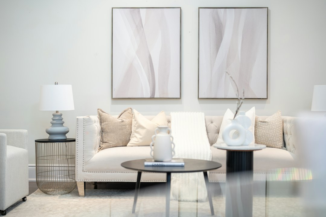 A modern living room with neutral tones and abstract art