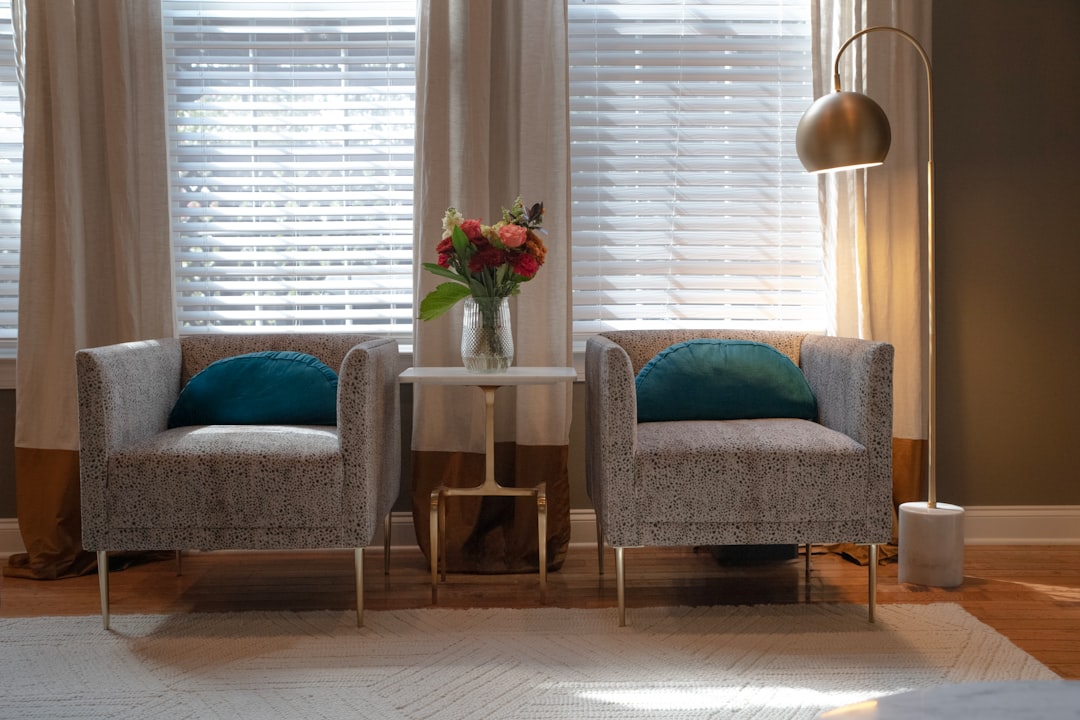 A living room with two chairs and a table